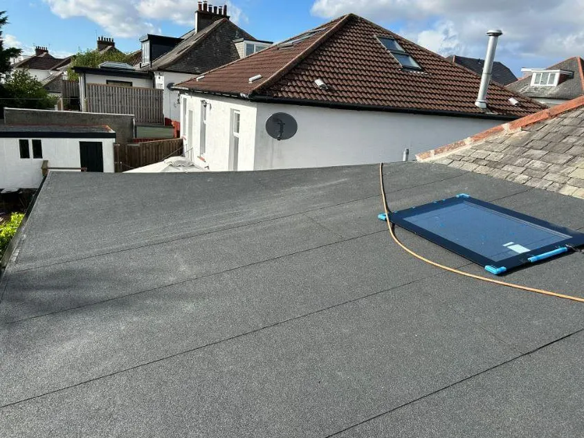 A new flat roof with a roof light being finished