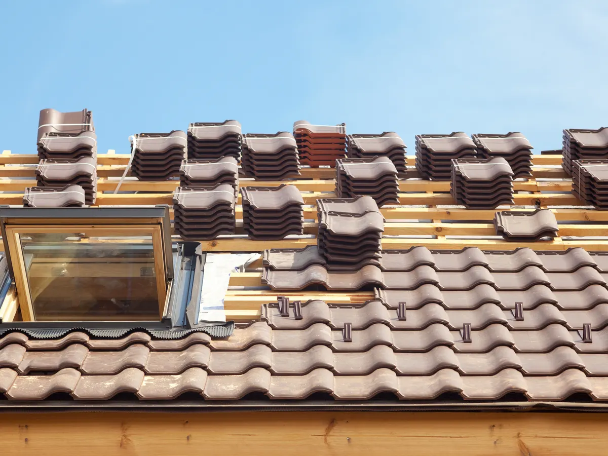 Roof tiles laid out on new battens ready for fixing