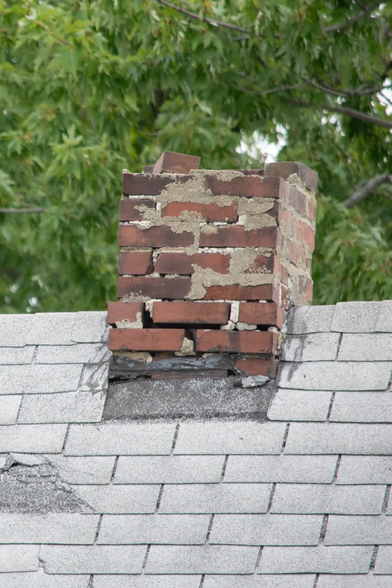 A chimney stack with crumbling brickwork
