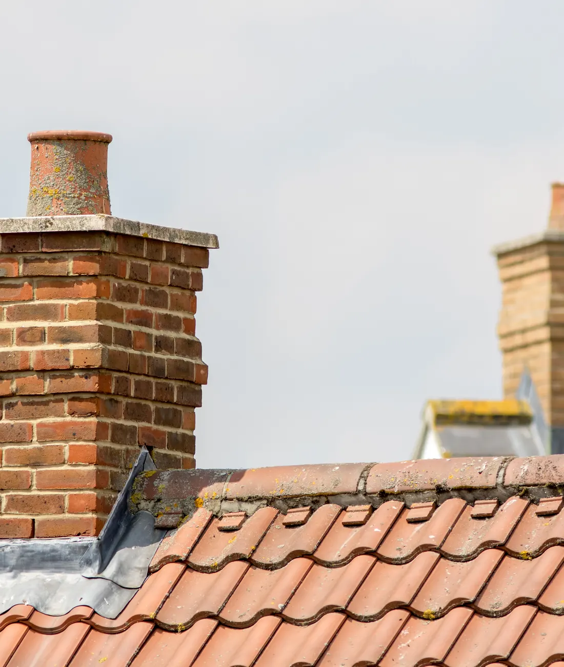 Brick chimney stacks on a clay tiled roof