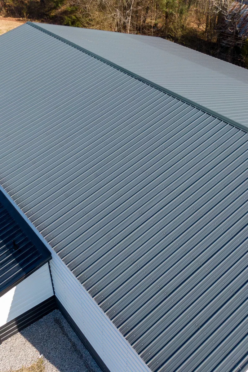 An industrial building with a long metal roof, seen from above