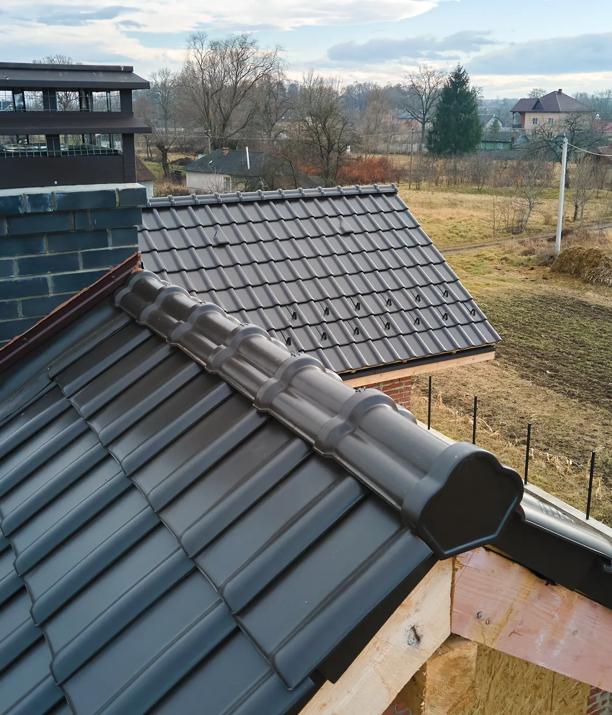 Dry-fixed ridge tiles on a grey tiled roof