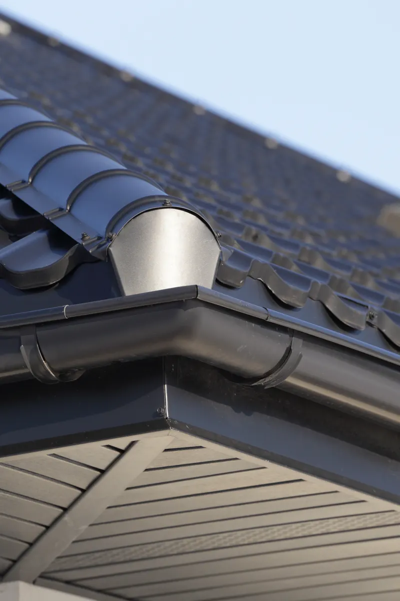 Grey soffit and fascia below a tiled roof
