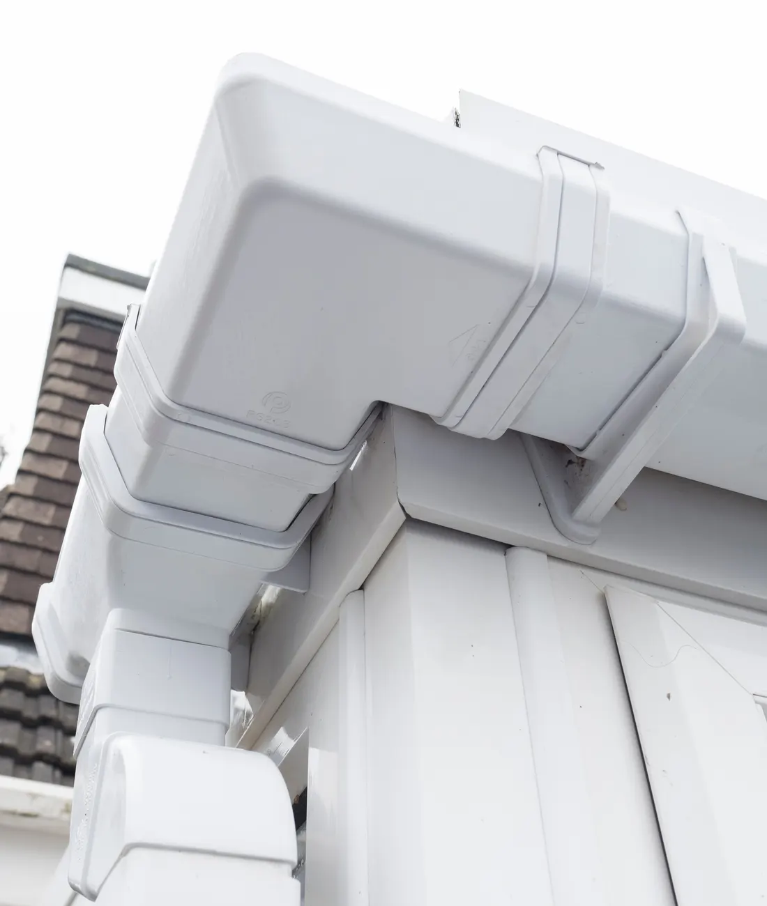 White uPVC fascia and soffit at the corner of a house