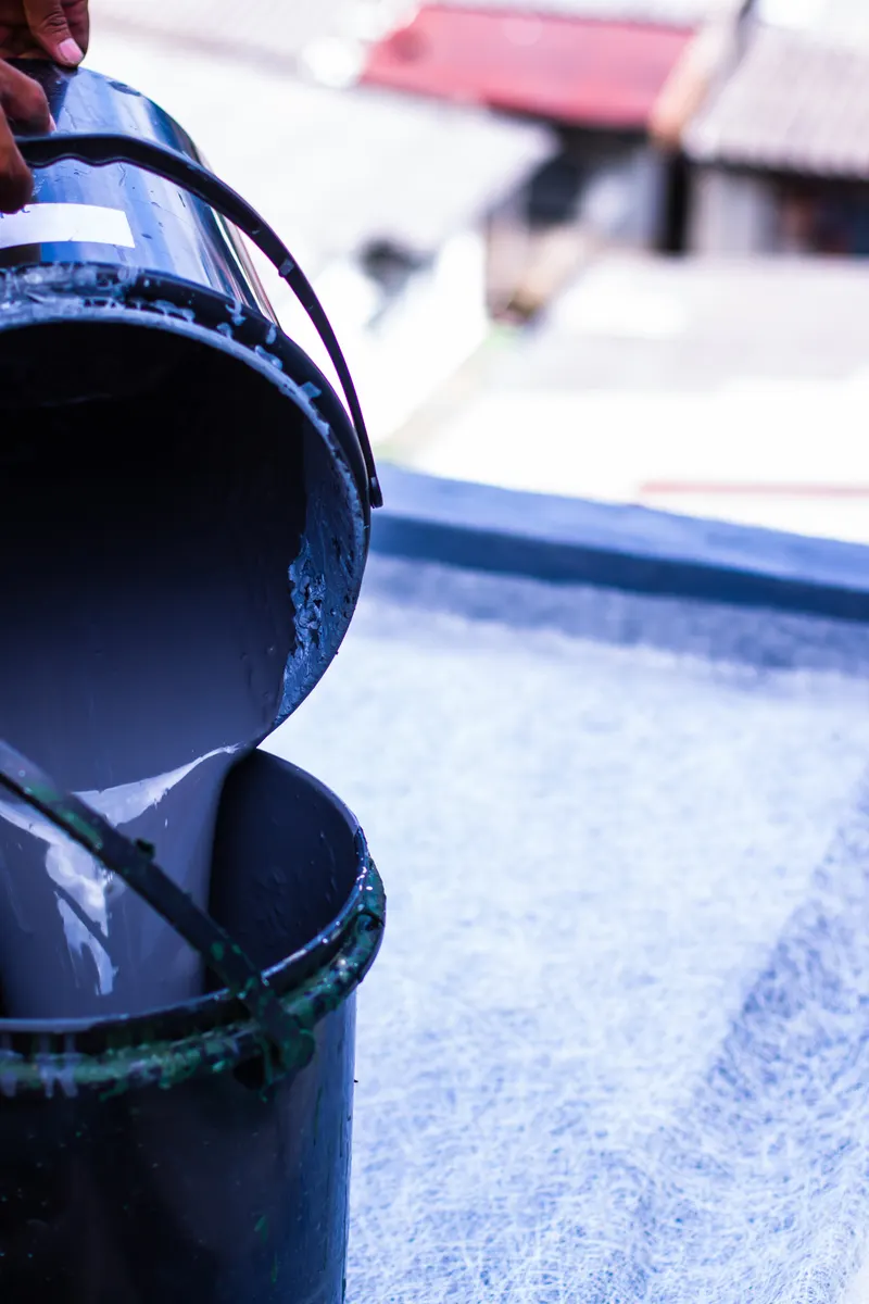 Resin being poured for a fibreglass roof