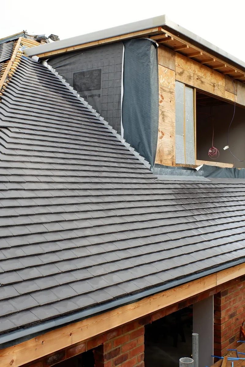 A new tiled roof going on around a dormer