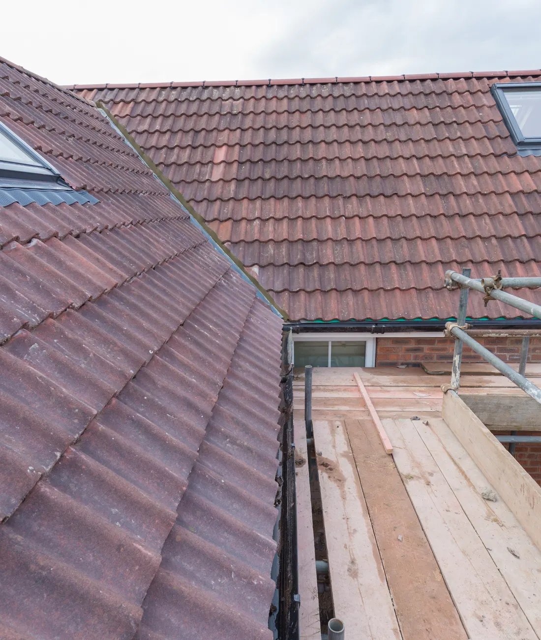 A house roof being re-tiled behind a scaffold