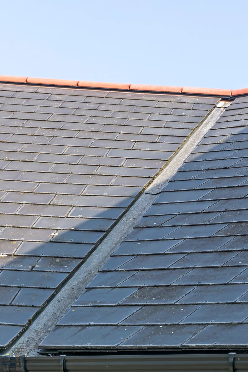 A slate roof valley lined with lead